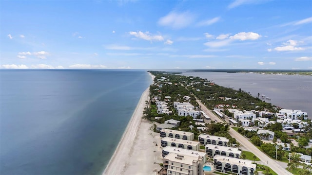 drone / aerial view featuring a water view and a view of the beach