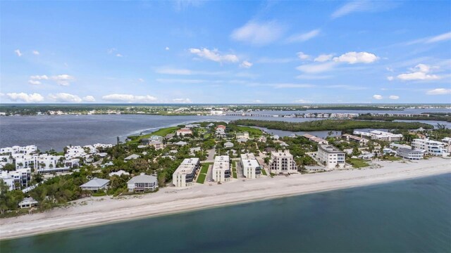 bird's eye view with a water view and a beach view