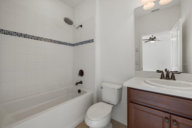 full bathroom with toilet, vanity, tiled shower / bath, and ceiling fan