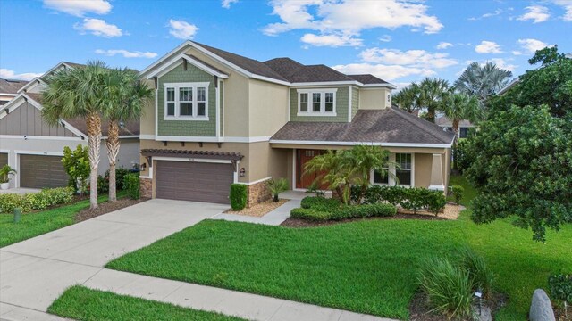 view of front of property with a garage and a front lawn