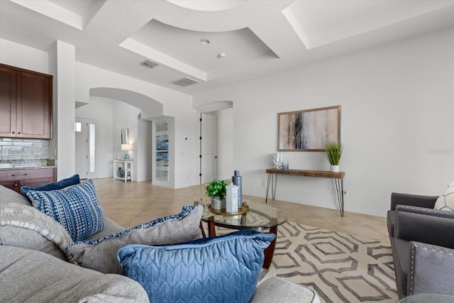 tiled living room featuring coffered ceiling