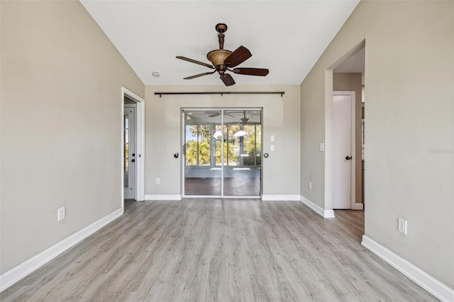 empty room with ceiling fan and light hardwood / wood-style floors