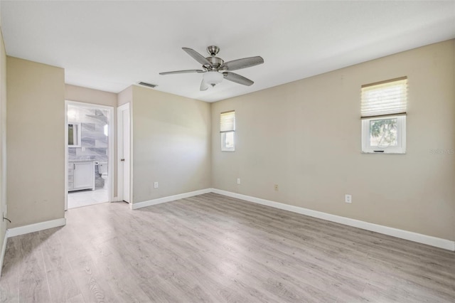 empty room with ceiling fan and light wood-type flooring