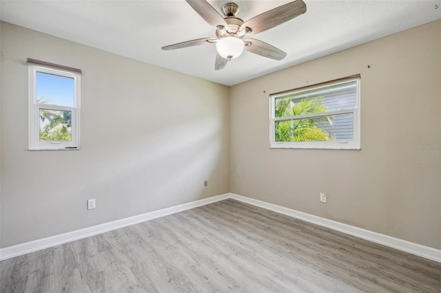 spare room featuring ceiling fan and light hardwood / wood-style flooring