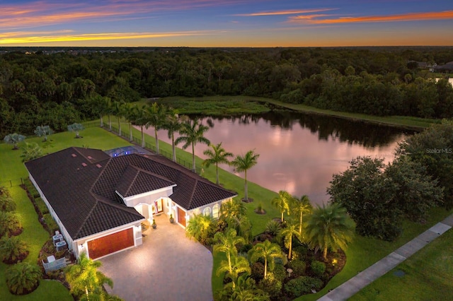 aerial view at dusk with a water view