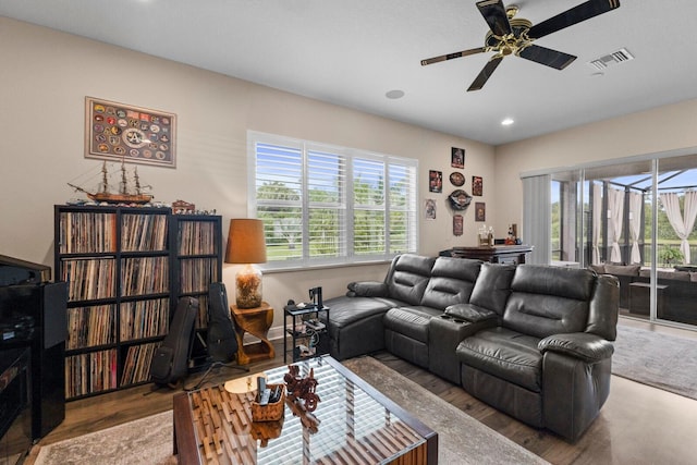 living room with ceiling fan and hardwood / wood-style flooring