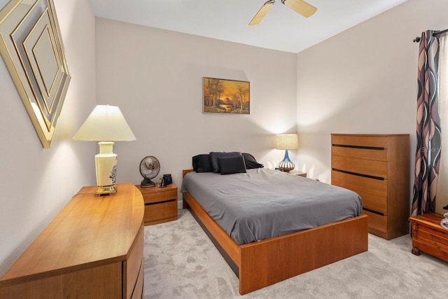 bedroom featuring light colored carpet and ceiling fan