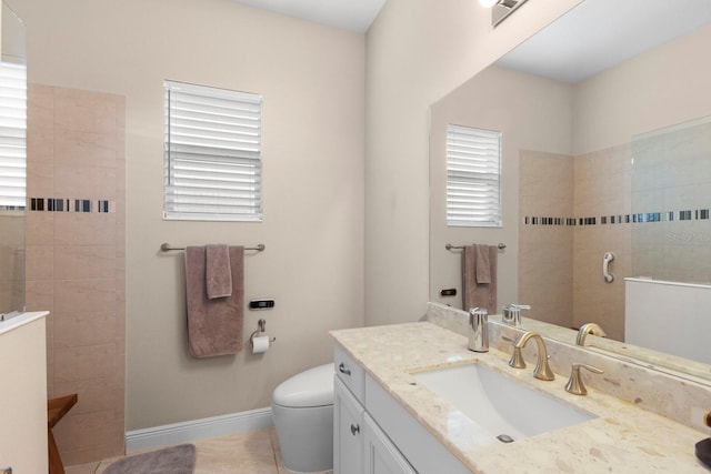 full bath featuring toilet, visible vents, vanity, baseboards, and walk in shower