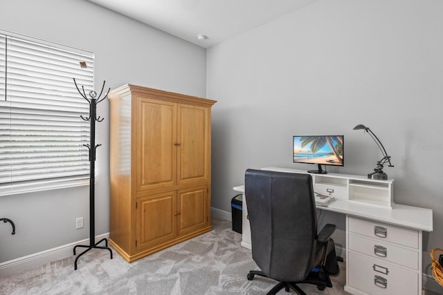 office featuring light carpet and baseboards