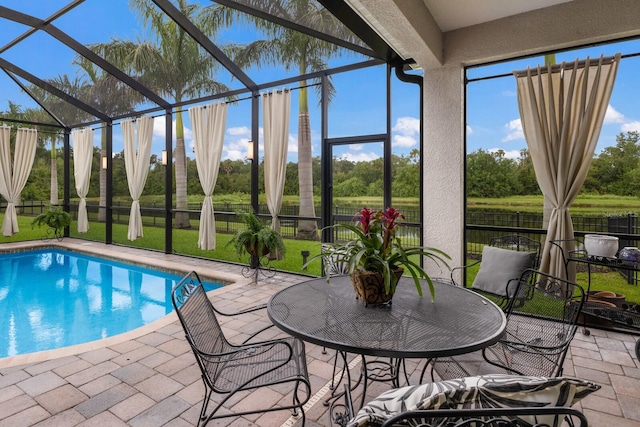 view of swimming pool with a fenced in pool, a lanai, a patio, and a lawn