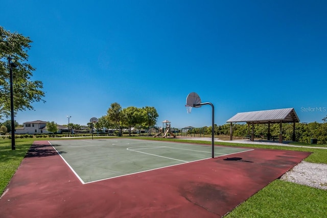 view of sport court featuring basketball hoop, a gazebo, and a yard