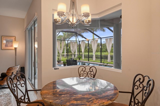 dining space with a sunroom and a notable chandelier