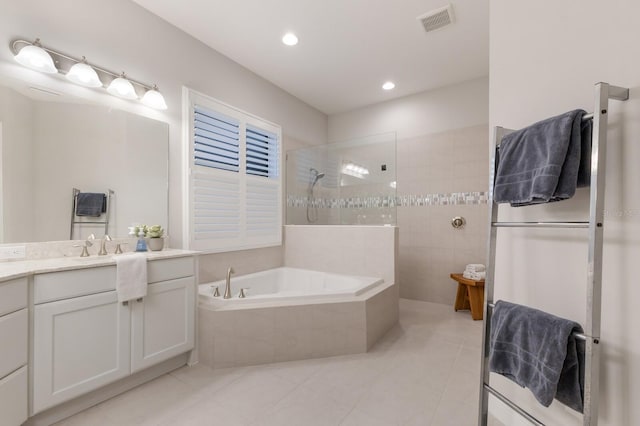 full bathroom with vanity, visible vents, a bath, tile patterned floors, and walk in shower