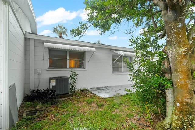 view of side of home with central air condition unit