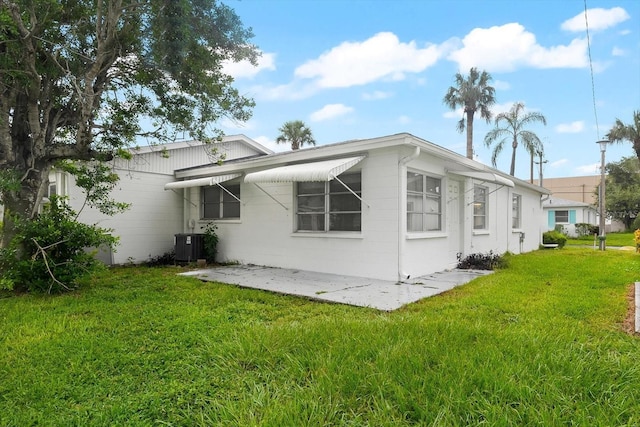 back of house with a patio, central AC, and a yard