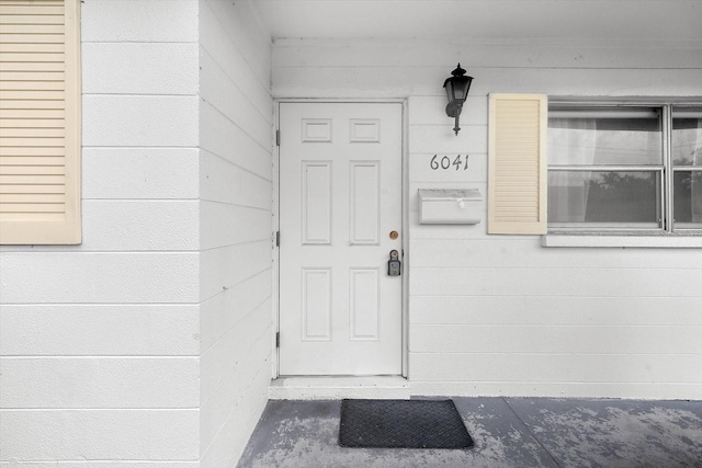 doorway to property with concrete block siding