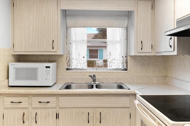 kitchen with decorative backsplash, sink, light brown cabinets, and exhaust hood