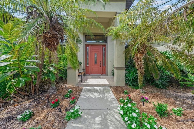 property entrance with stucco siding