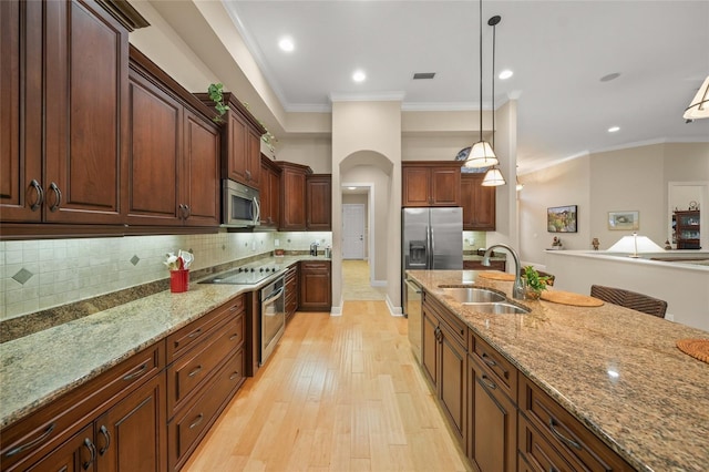 kitchen with backsplash, stainless steel appliances, crown molding, and a sink