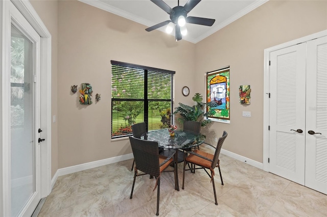 dining space featuring baseboards, a ceiling fan, and crown molding