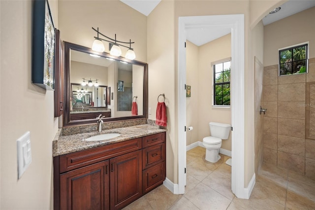 full bath with tile patterned floors, toilet, tiled shower, baseboards, and vanity