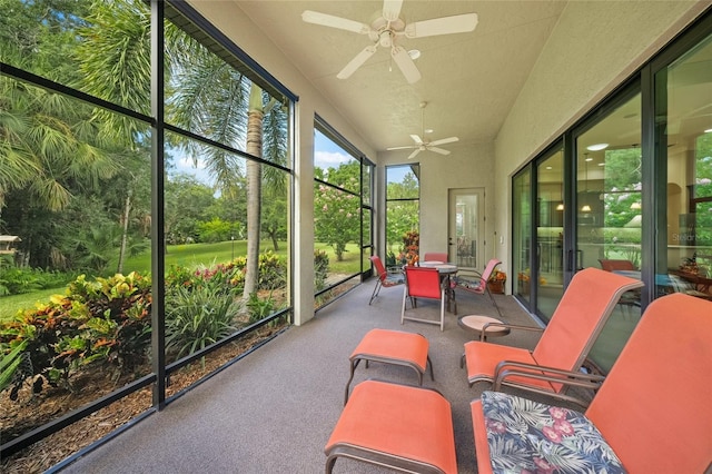 sunroom / solarium with a ceiling fan