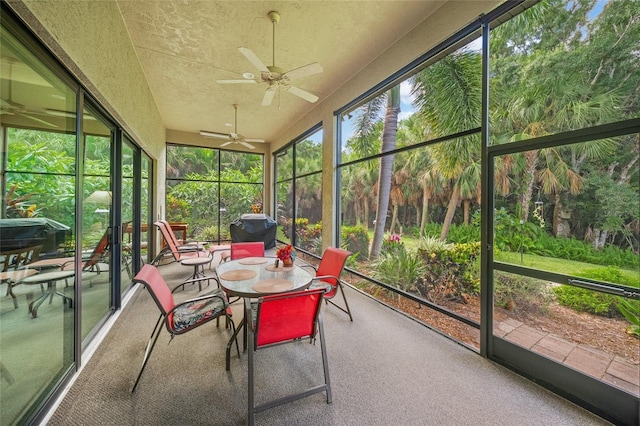 sunroom featuring ceiling fan