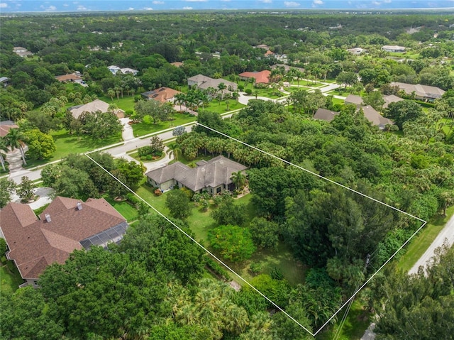 aerial view featuring a residential view and a wooded view