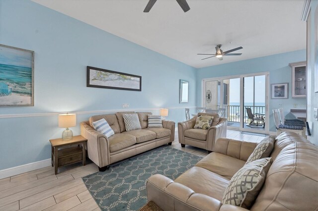 living room featuring a water view, ceiling fan, and light hardwood / wood-style flooring