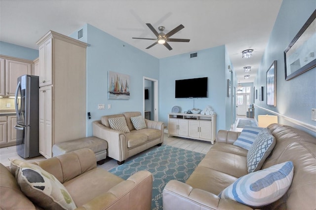 living room featuring light hardwood / wood-style flooring and ceiling fan