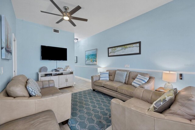 living room with ceiling fan and light hardwood / wood-style floors