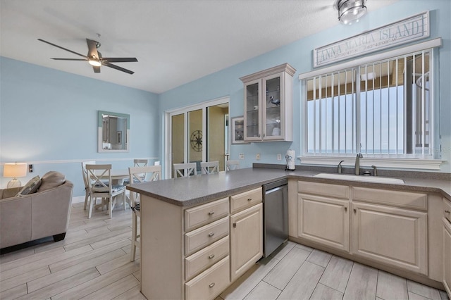 kitchen featuring dishwasher, sink, ceiling fan, and kitchen peninsula