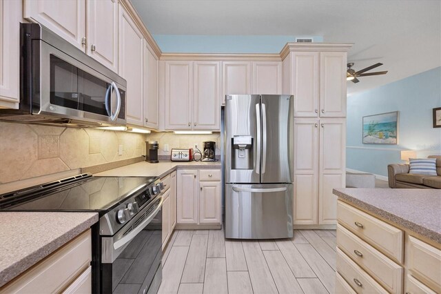 kitchen featuring backsplash, stainless steel appliances, and ceiling fan