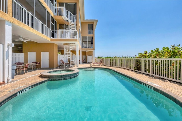 view of swimming pool with a hot tub and a patio area