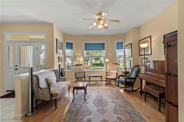 living area featuring light hardwood / wood-style flooring and ceiling fan