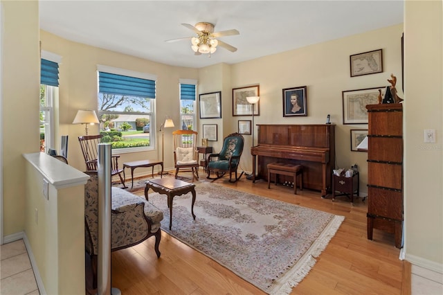 living area featuring light hardwood / wood-style floors and ceiling fan