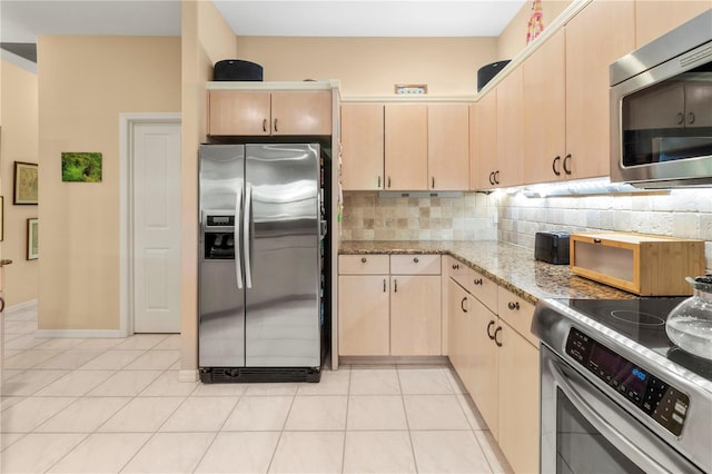 kitchen with appliances with stainless steel finishes, light brown cabinetry, and light tile patterned floors