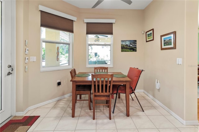 dining space with ceiling fan and light tile patterned floors