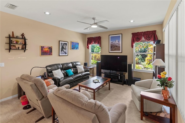 living room with ceiling fan, light colored carpet, and a healthy amount of sunlight