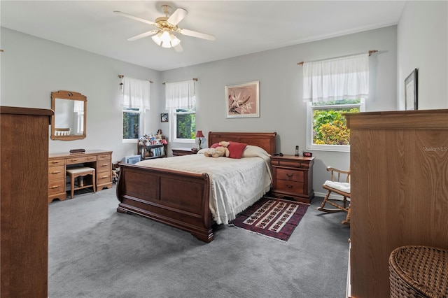 carpeted bedroom with ceiling fan and multiple windows