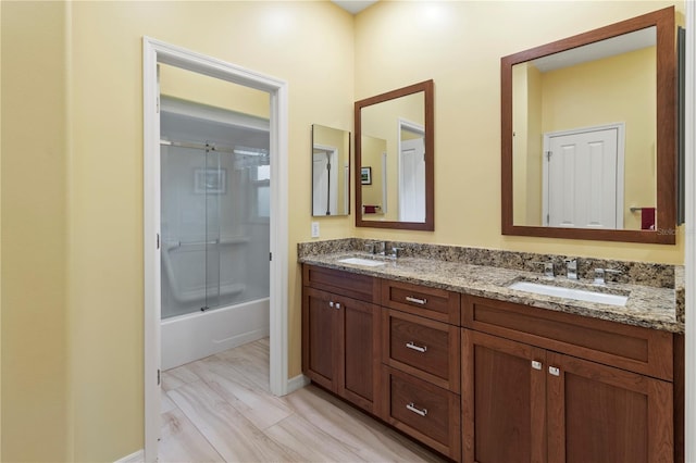 bathroom featuring shower / bath combination with glass door, vanity, and hardwood / wood-style flooring