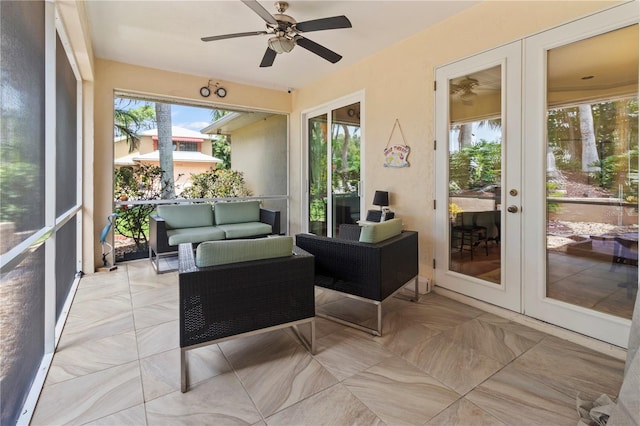 sunroom / solarium featuring french doors and ceiling fan