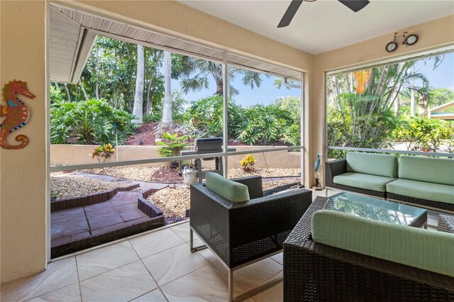 sunroom / solarium featuring ceiling fan