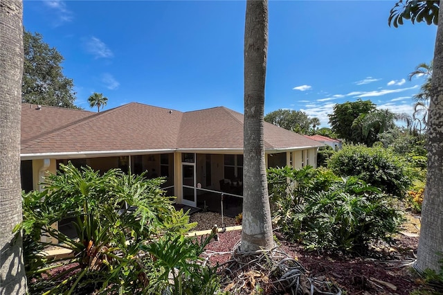 view of side of home with a sunroom