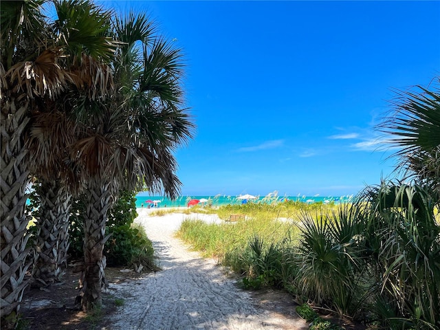 view of road featuring a water view and a view of the beach