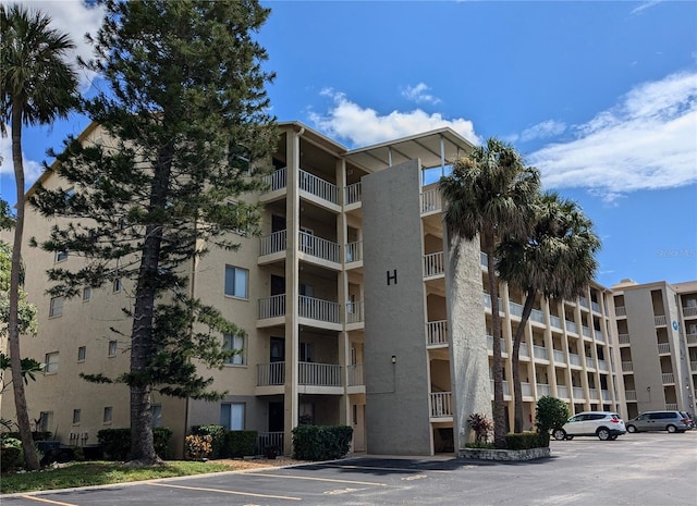 view of building exterior with uncovered parking