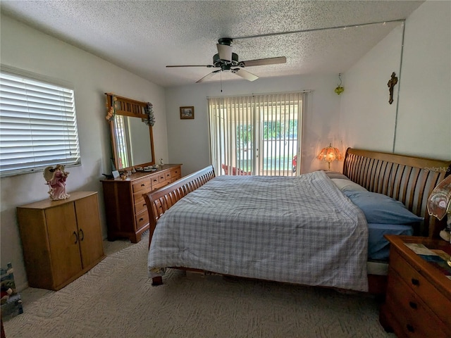 bedroom with access to outside, light colored carpet, ceiling fan, and a textured ceiling