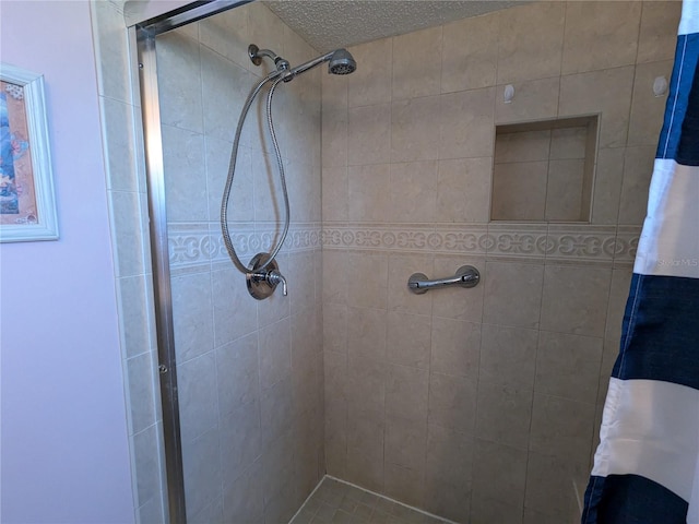 full bathroom with a shower stall and a textured ceiling