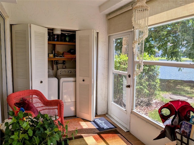 sunroom with washer and clothes dryer