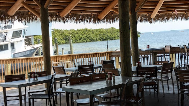 exterior space with outdoor dining area and a water view